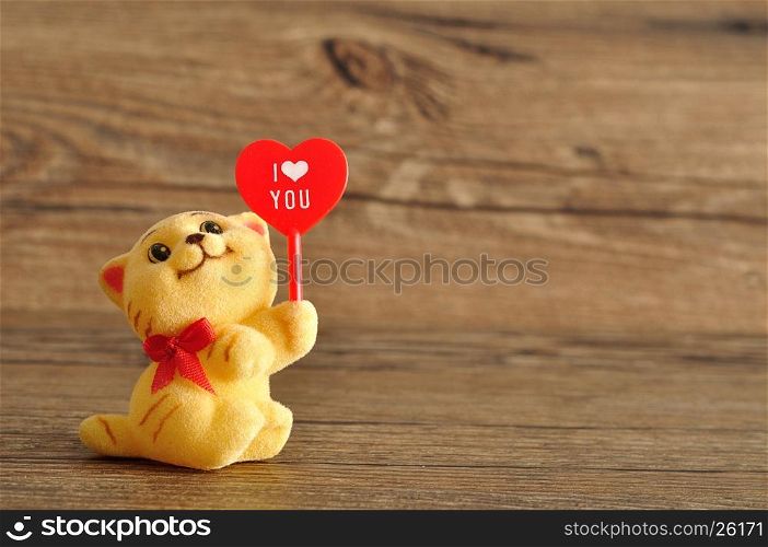Valentine's day. A kitten figurine holding a red heart