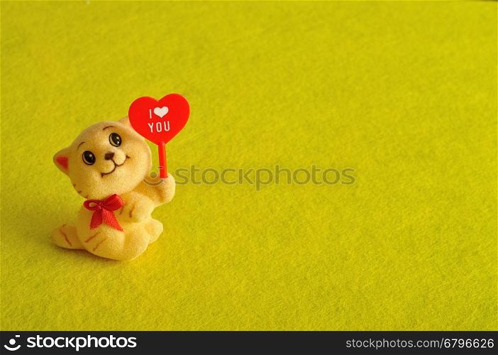 Valentine's day. A kitten figurine holding a red heart with the word i love you