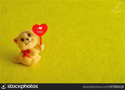 Valentine's day. A kitten figurine holding a red heart with the word i love you