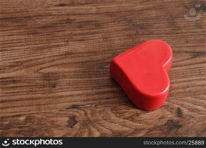 Valentine's day. A red heart isolated on a wooden background
