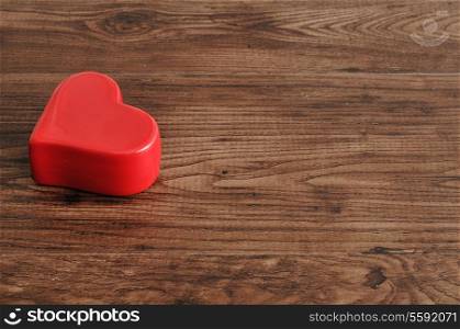 Valentine's day. A red heart isolated on a wooden background