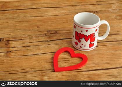 Valentine's Day. A white mug with the word love on it with a red heart