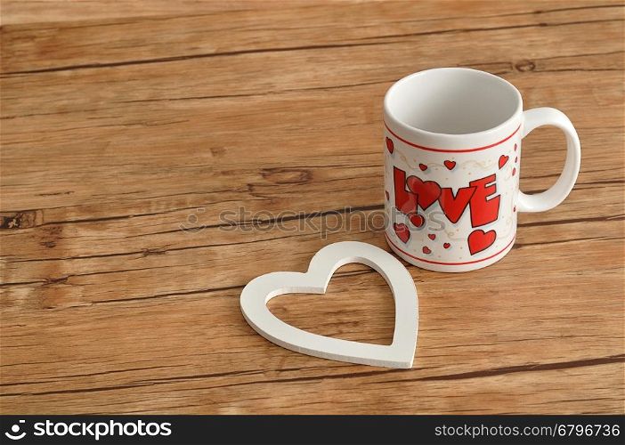 Valentine's Day. A white mug with the word love on it with a white heart