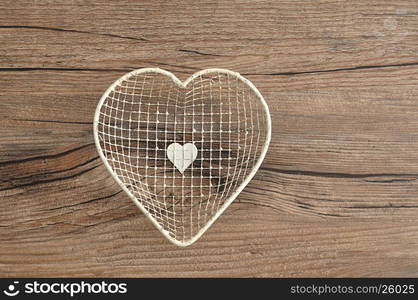 Valentine's Day. A white wire basket in a shape of a heart