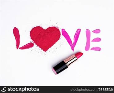 Valentine’s Day background. Red and pink lipstick smeared in the shape of the letters love. Isolated on white background. Cosmetic products. Beauty and makeup concept