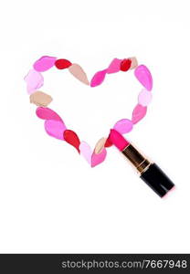 Valentine’s Day background. Red and pink lipstick smeared in the shape of heart. Isolated on white background. Cosmetic products