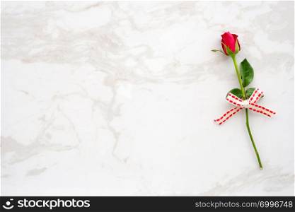 Valentine?s day background, template, Red rose, love symbol, on white marble background with copy space for text, flat lay