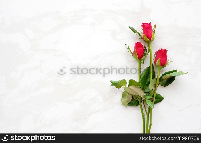Valentine?s day background, template, Red roses, love symbol, on white marble background with copy space for text, flat lay