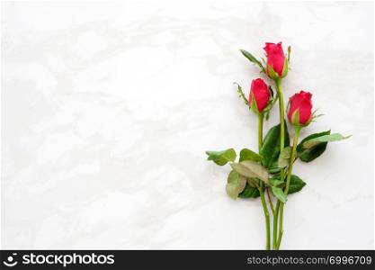 Valentine?s day background, template, Red roses, love symbol, on white marble background with copy space for text, flat lay