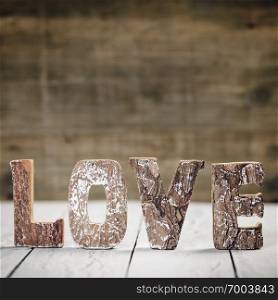 Valentine’s Day concept.  Love word letters. Love wood letters on table. Love wood letters close up.. Valentine’s Day concept. Love wooden letters on white rustic background