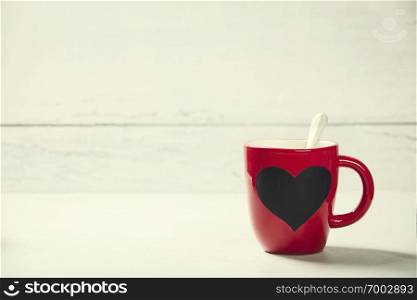 Valentine’s Day concept. Red Cup on a Wooden Background. . Valentine’s Day. Red Cup on a Wooden Background.