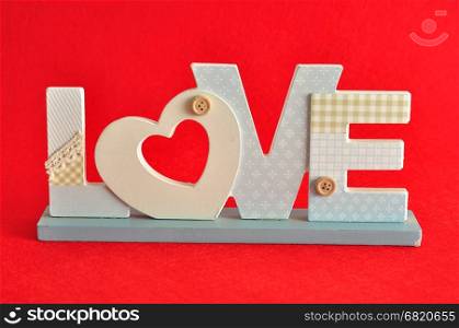 Valentine's Day. Love in blue letters isolated on a red background
