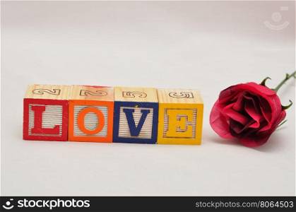 Valentine's Day.Love Spelled with colorful alphabet blocks and a red rose