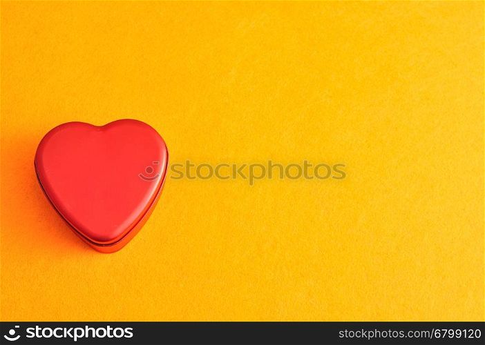 Valentine's Day. Red heart isolated against a yellow background