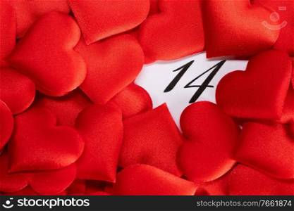 Valentine’s day red silk hearts on calendar with 14 february date background, love, celebration concept. Valentine’s day calendar