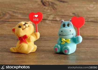 Valentine's day. Two figurines holding hearts