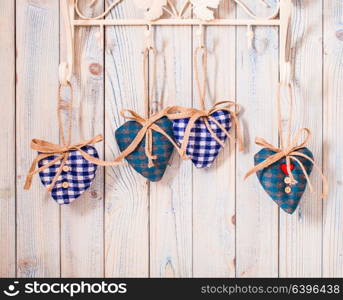 Valentine vintage decor - blue gingham hearts on the hooks. Christmas felt hearts