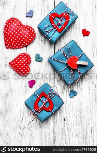 Valentines concept with wrapped gift on white wooden table. Gift boxes with ribbons