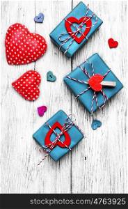Valentines concept with wrapped gift on white wooden table. Gift boxes with ribbons