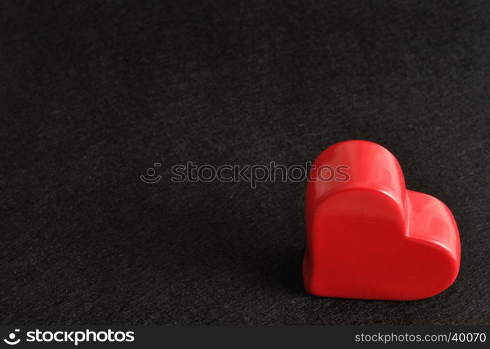 Valentines day. A red heart isolated against a black background