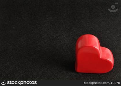 Valentines day. A red heart isolated against a black background