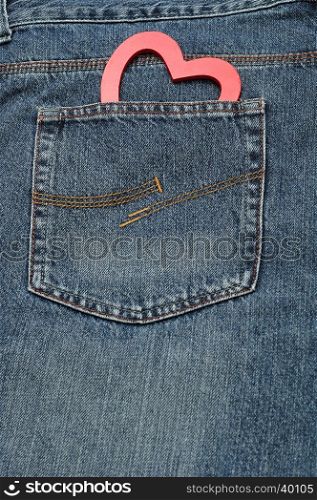 Valentines day. A red heart sticking out of a back pocket of a denim jean