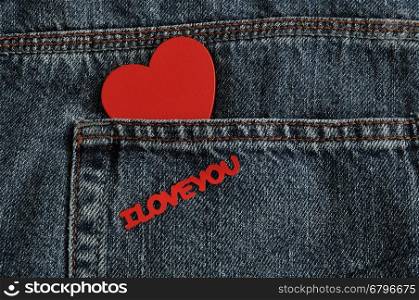Valentines day. A red heart with the words I love you sticking out of a back pocket of a denim jean