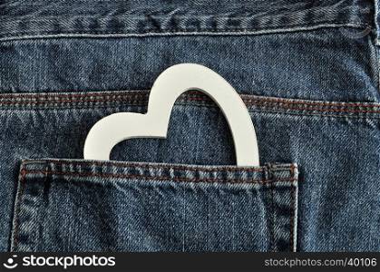 Valentines day. A white heart sticking out of a back pocket of a denim jean