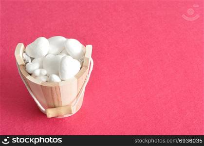 Valentines day. A wooden bucket filled with polystyrene hearts