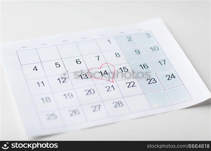 valentines day and holidays concept - close up of calendar sheet with 14th february date marked by red heart shape. close up of 14th february date in calendar