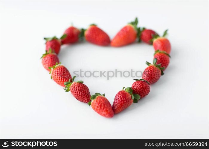 valentines day and romantic concept - heart shape made of fresh strawberries. heart shape made of strawberries