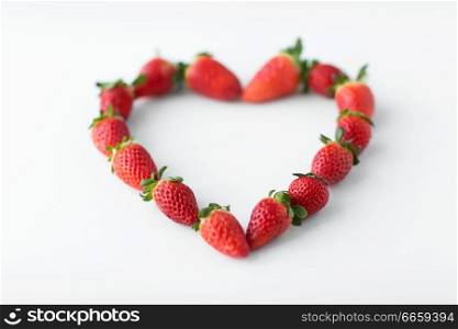 valentines day and romantic concept - heart shape made of fresh strawberries. heart shape made of strawberries