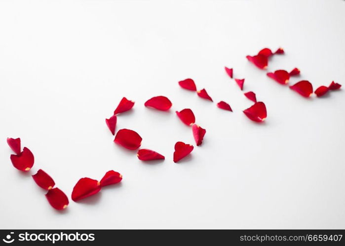 valentines day and romantic concept - word love made of red rose petals on white background. word love made of red rose petals