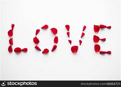 valentines day and romantic concept - word love made of red rose petals on white background. word love made of red rose petals