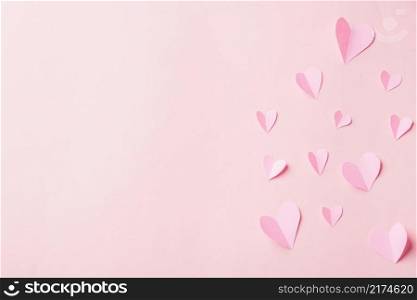 Valentines’ day background. Pattern beautiful pink paper hearts cut composition greeting gift card isolated on pink background with copy space, Symbol of love Top View from above
