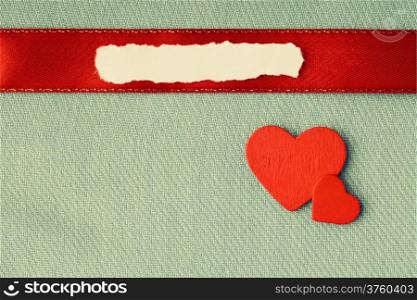 Valentines day background. Vintage paper blank copy space red hearts love symbol on green fabric textile material