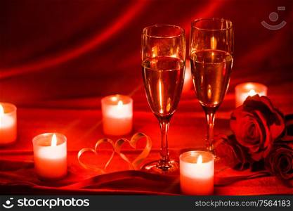 Valentines day background with champagne glasses roses candles and hearts. Champagne glasses and candles