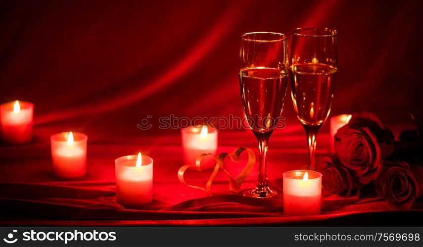 Valentines day background with champagne glasses roses candles and hearts. Champagne glasses and candles
