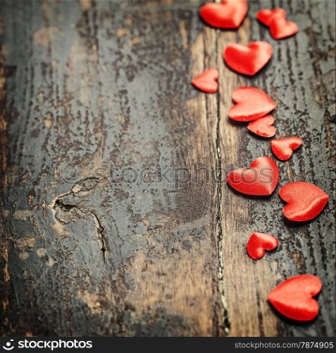 Valentines Day background with hearts on wooden background