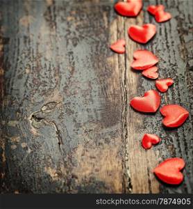 Valentines Day background with hearts on wooden background