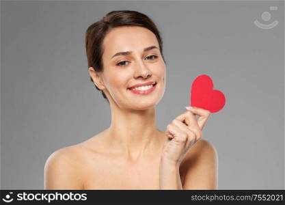 valentines day, beauty and love concept - happy smiling young woman with pink heart shape over grey background. beautiful woman with pink heart shape