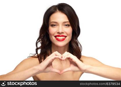 valentines day, beauty and people concept - happy smiling young woman with red lipstick making hand heart gesture over white background. beautiful woman with red lipstick and hand heart