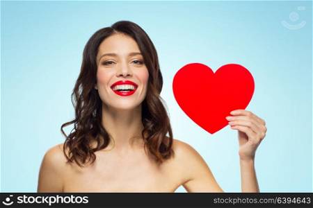 valentines day, beauty and people concept - happy smiling young woman with red lipstick and heart shape over blue background. beautiful woman with red lipstick and heart shape