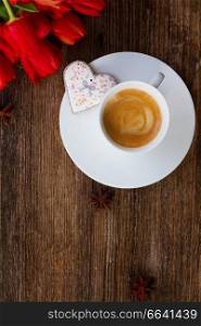 Valentines day coffee with fresh red tulips on wooden table, top view. Valentines day coffee