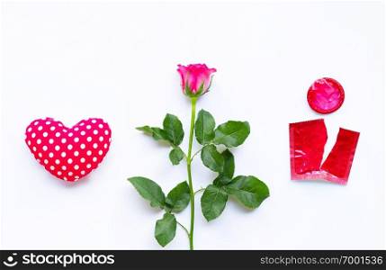 Valentines day concept, Heart with rose and red condom on white background.  