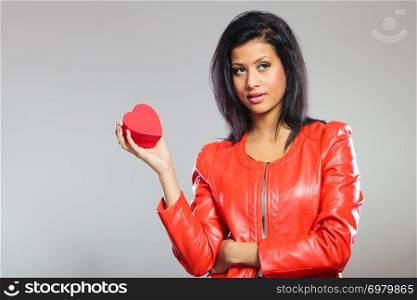 Valentines Day concept. Lovely cute african girl in stylish red jacket holding heart box gift present. Love time.. Girl in red holding heart gift