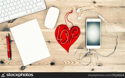 Valentines Day concept. Office Desk with Red Heart, Keyboard, Paper, Phone