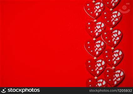 Valentines day concept. Textile red hearts on a red background, place for text.. Valentines day concept. Textile red hearts on a red background.