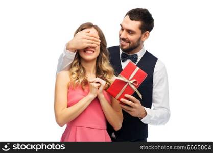 valentines day, couple, relationships and people concept - happy man giving woman surprise present. happy man giving woman surprise present