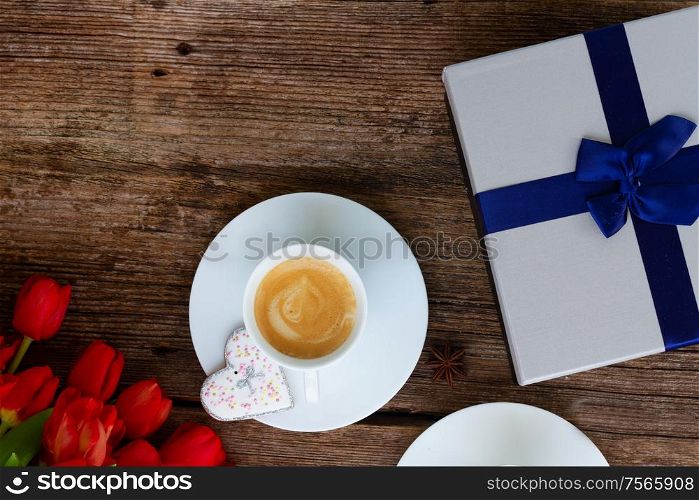 Valentines day cup of coffee with presemt box on wooden table with copy space. Valentines day coffee